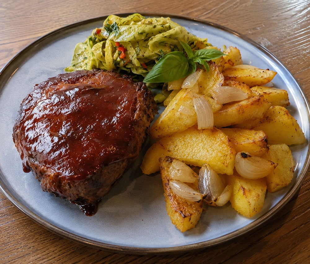 Pork neck with barbecue sauce and potatoes cooked with onions