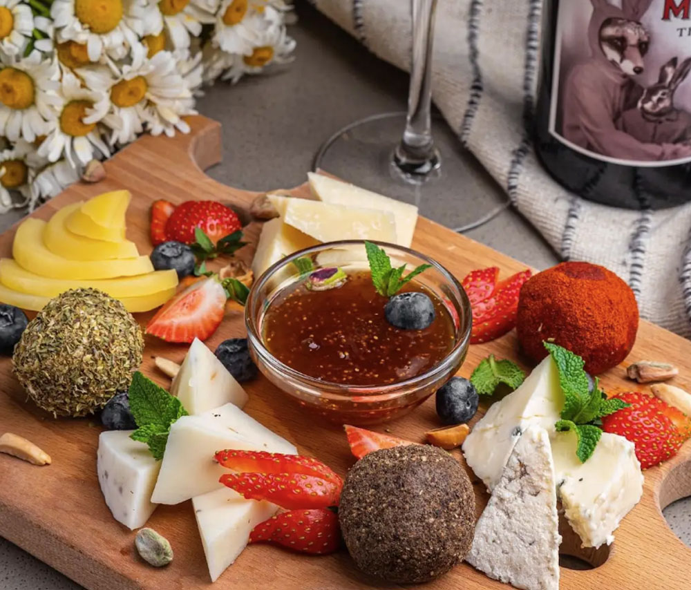 Assorted aged cheeses with homemade jam and dried fruits