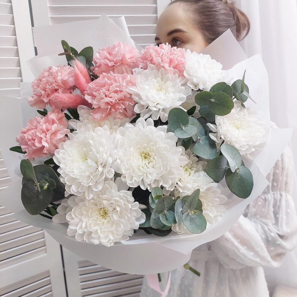 Delicate bouquet of the most durable flowers - dianthus and chrysanthemums with eucalyptus