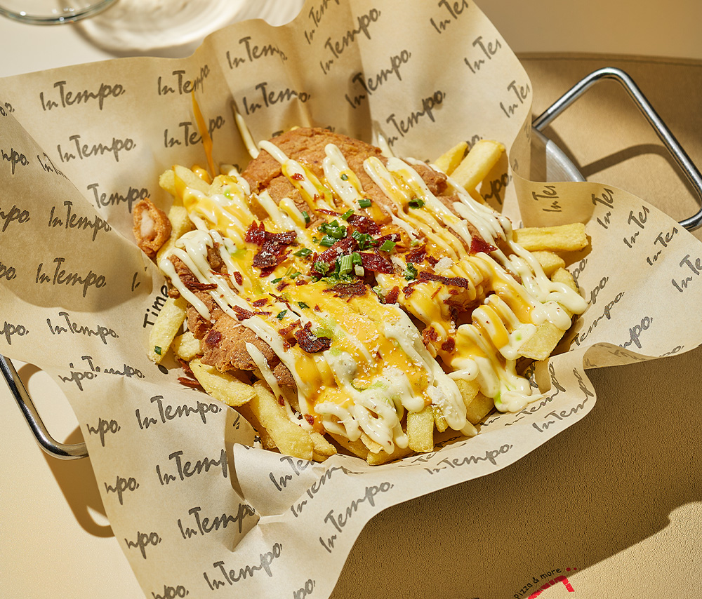 Crispy chicken breast with french fries and cheddar cheese